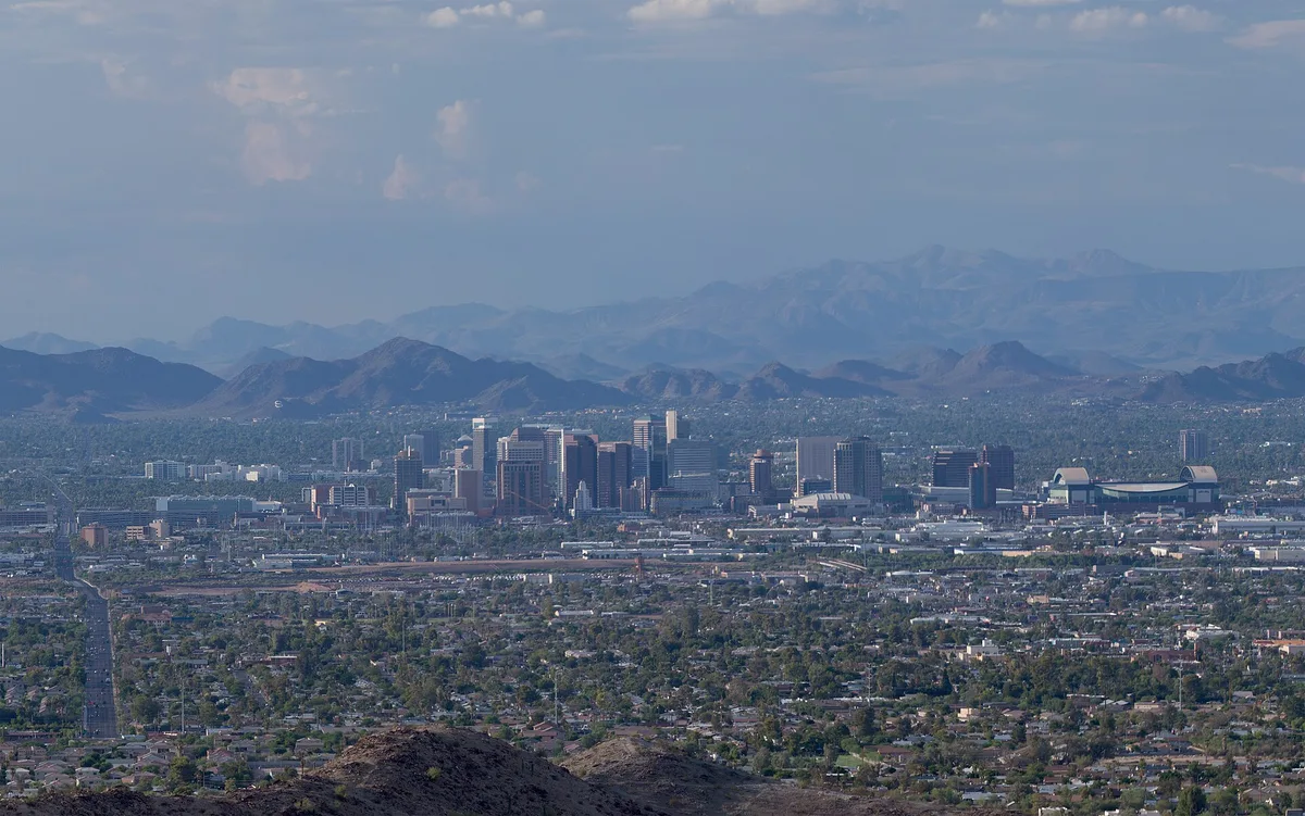 Downtown Phoenix skyline with desert mountains behind, seen from South Mountain