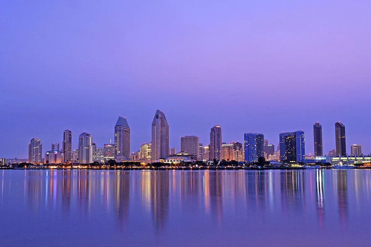 The San Diego skyline at dusk reflected in the bay, seen from Coronado