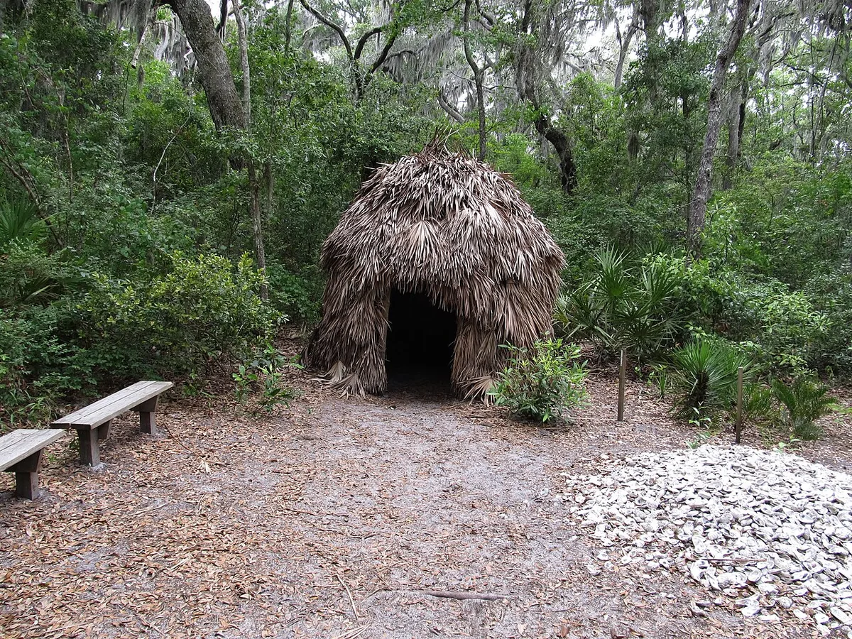 A reconstructed Timucua palm-thatch hut beside an oyster shell midden in the Timucuan Preserve