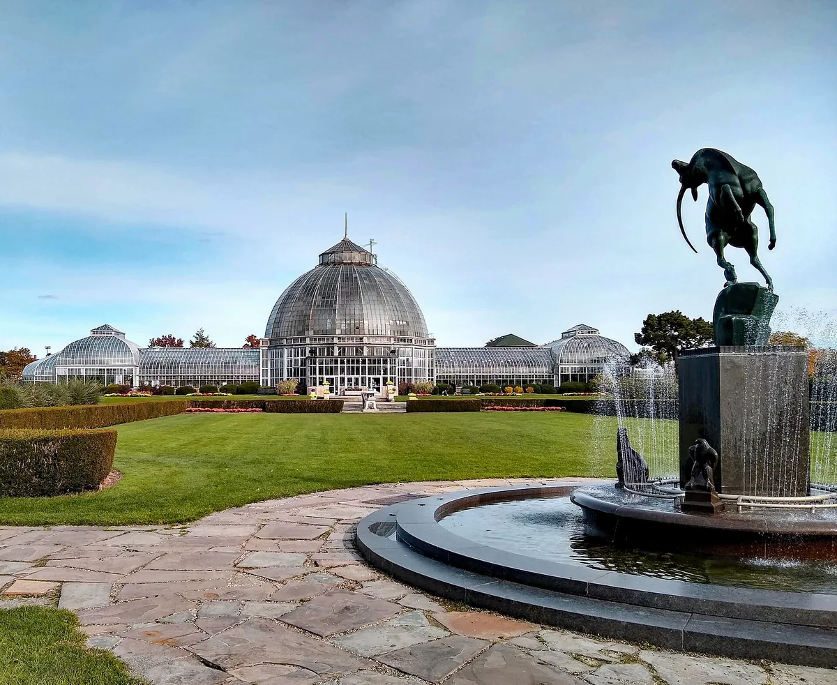 The glass dome of the Anna Scripps Whitcomb Conservatory on Belle Isle, with a fountain in the foreground