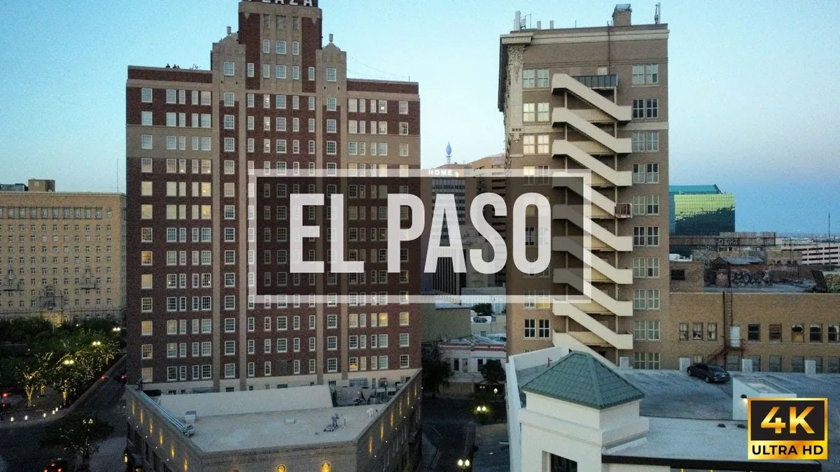 Aerial view of downtown El Paso at dusk with the Plaza Hotel and Bassett Tower