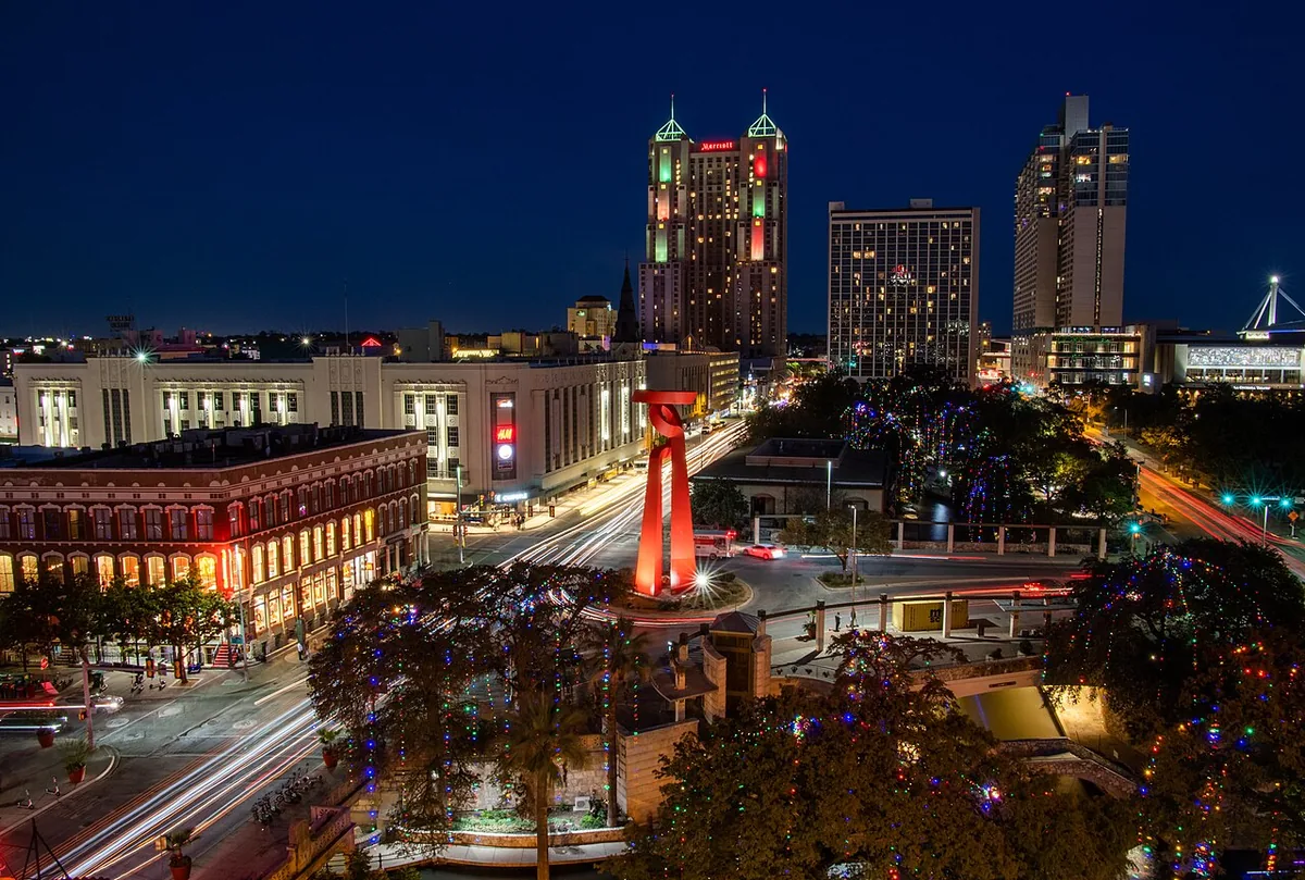 Downtown San Antonio at night with the Torch of Friendship sculpture and holiday lights