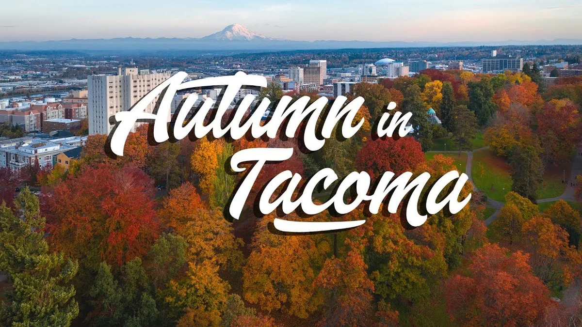 Aerial view of Wright Park and downtown Tacoma in fall color, with Mount Rainier on the horizon