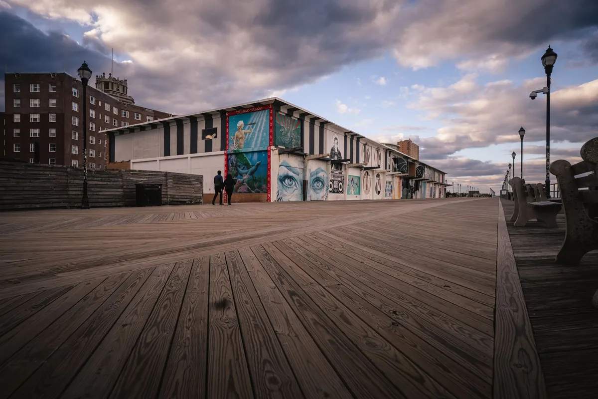 The Asbury Park boardwalk with murals under a dramatic sky