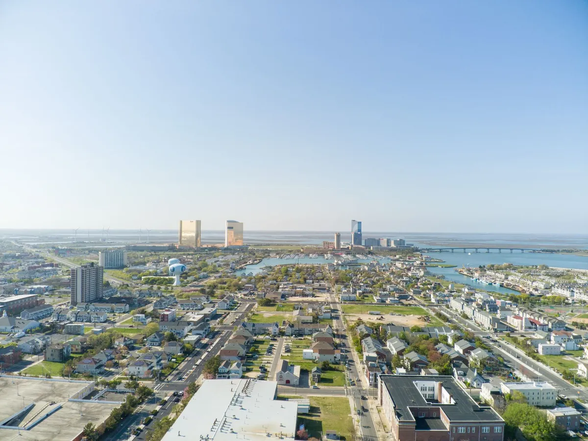 Aerial view of Atlantic City's cityscape and coastline under clear skies