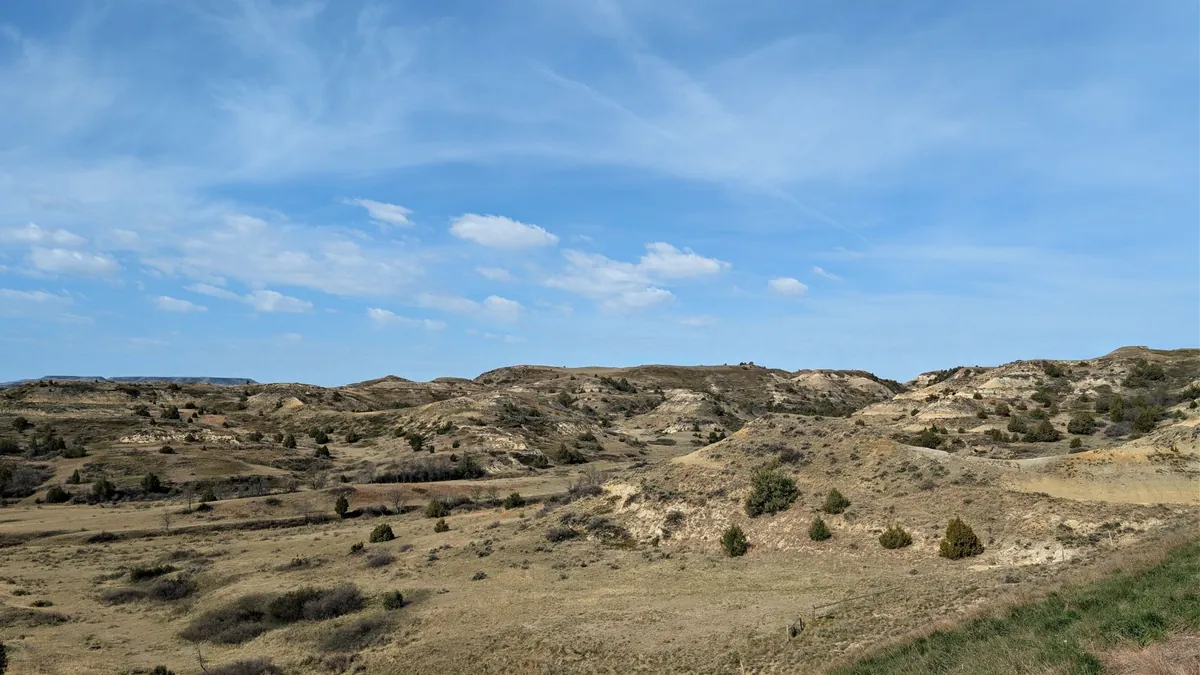 Panoramic view of the rugged North Dakota badlands under a clear blue sky