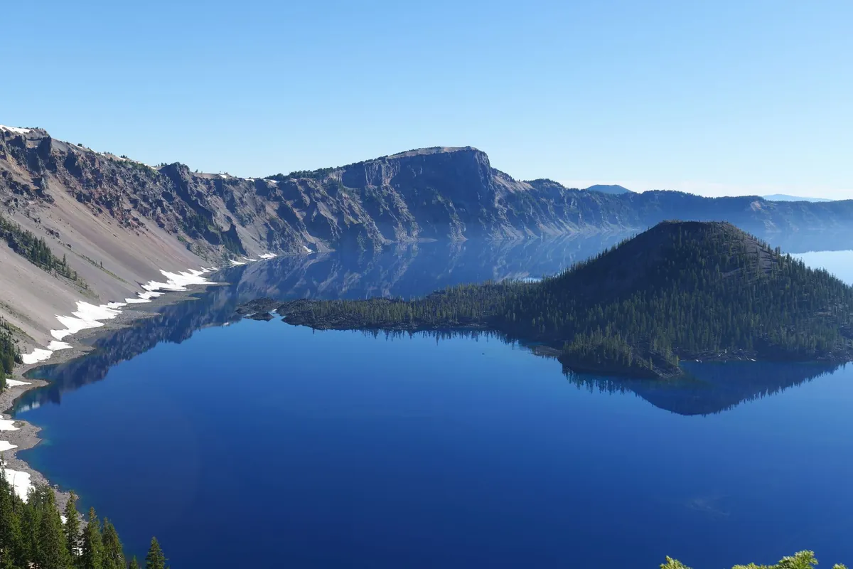 Aerial view of Crater Lake's deep blue water and caldera cliffs
