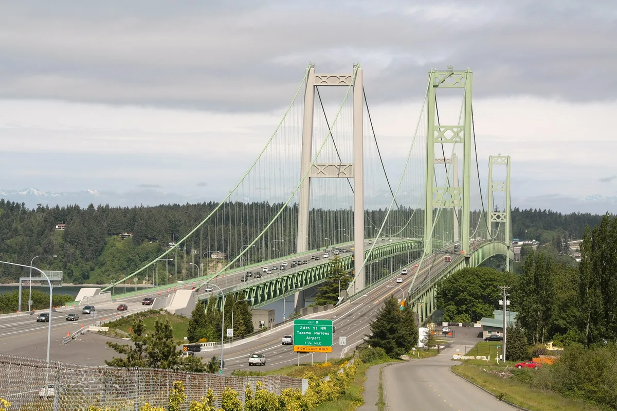 The twin spans of the Tacoma Narrows Bridge carrying traffic across the Narrows, seen from the Tacoma side